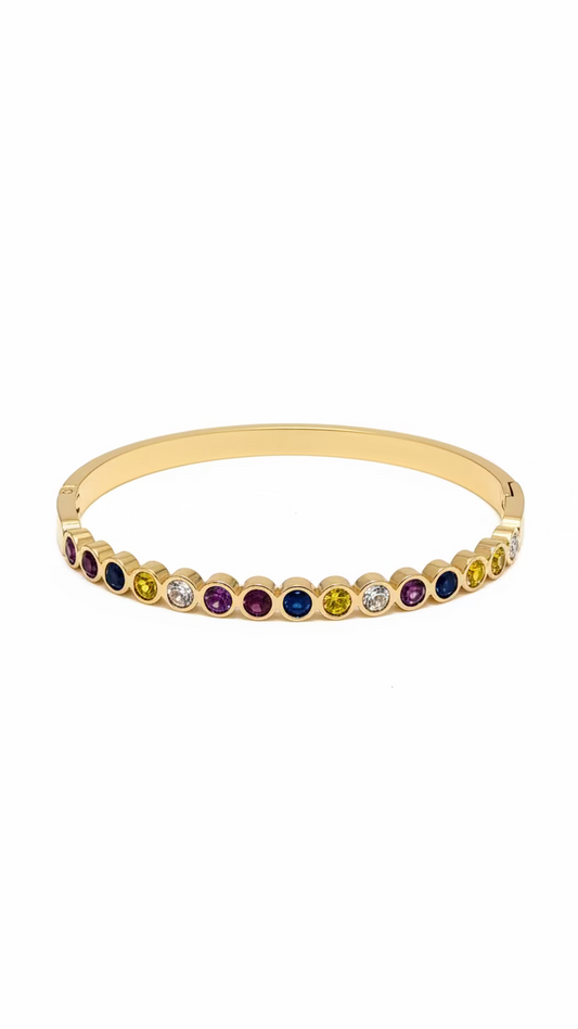 Gold bracelet with multicolored gemstones on a light gray background